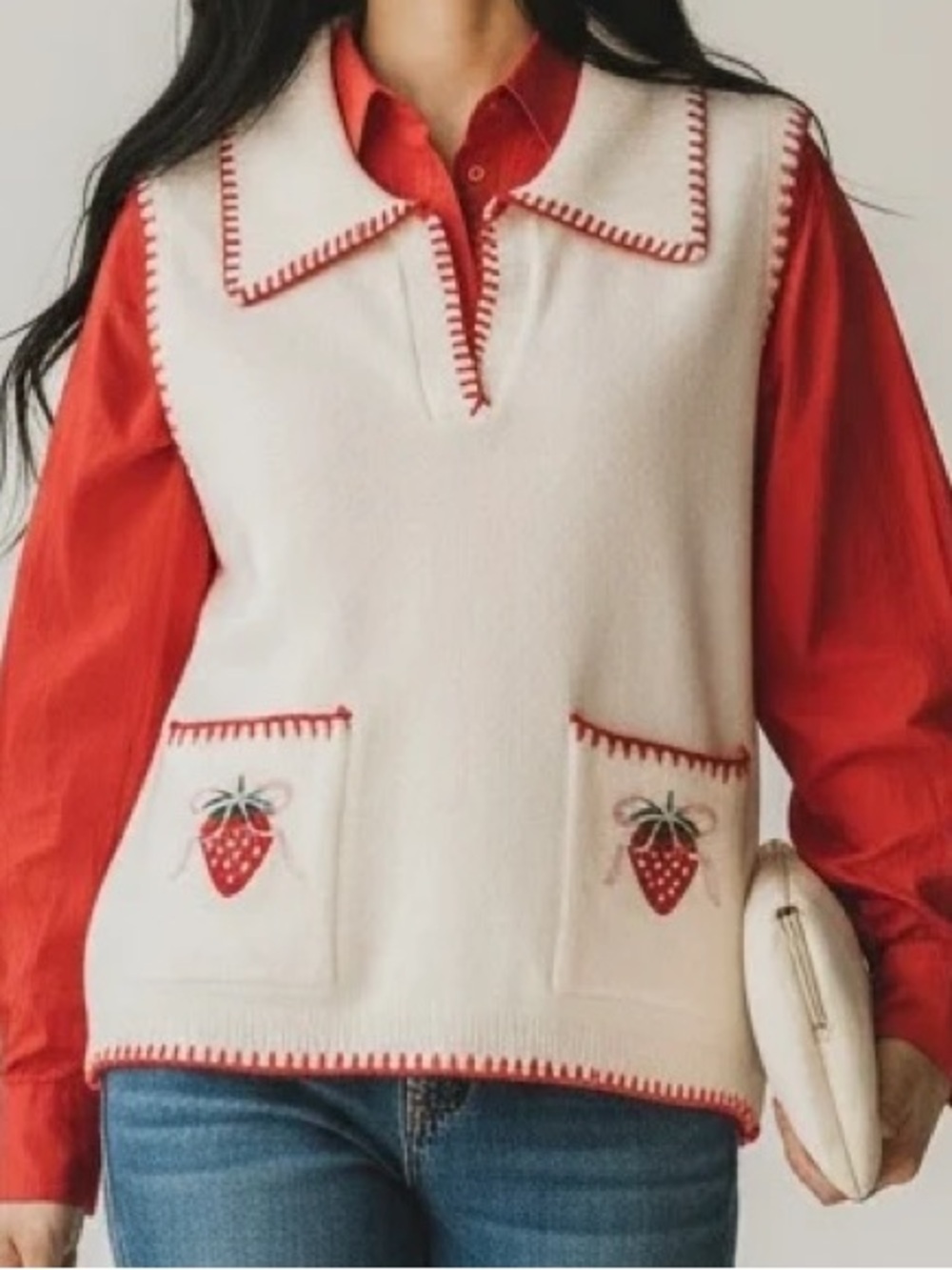 BiBi cream-colored knit sleeveless vest by featuring red trim and embroidered